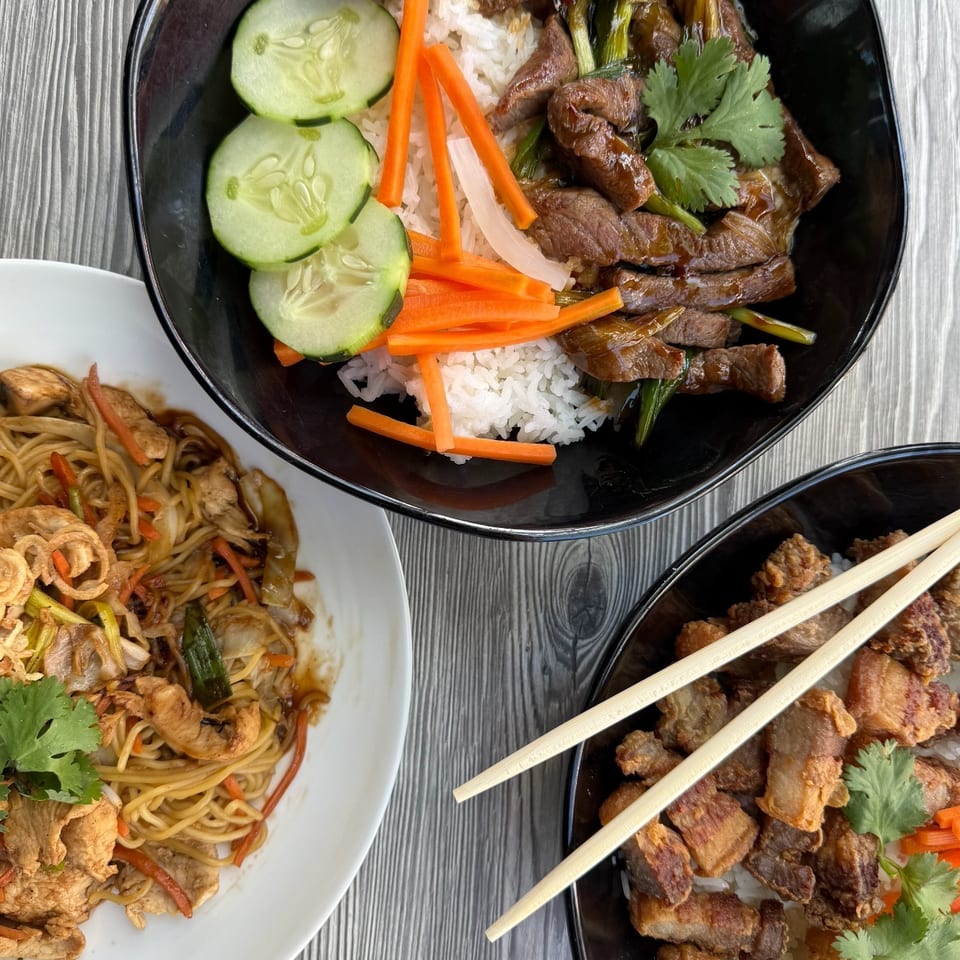 Three Asian dishes: beef and rice, noodles with chicken, and crispy pork belly with rice.