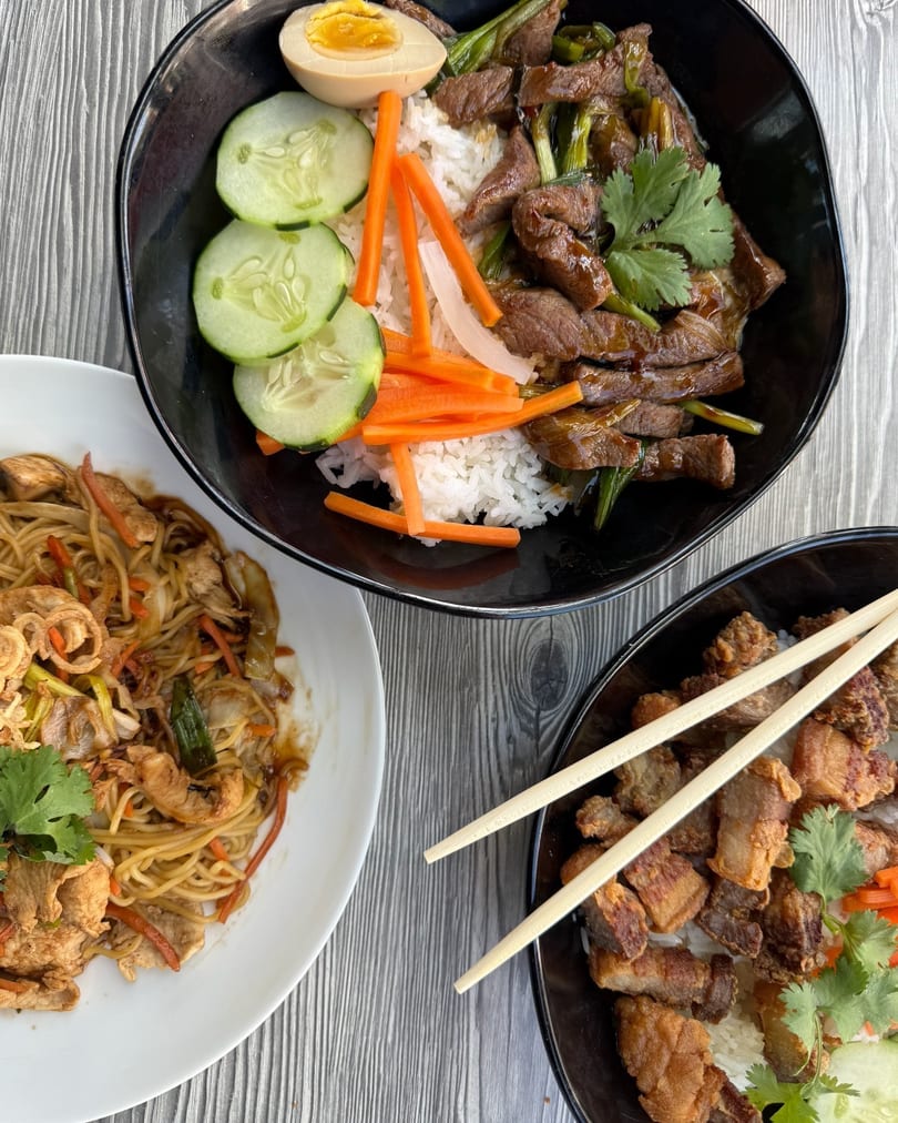 Three Asian dishes: beef and rice, noodles with chicken, and crispy pork belly with rice.